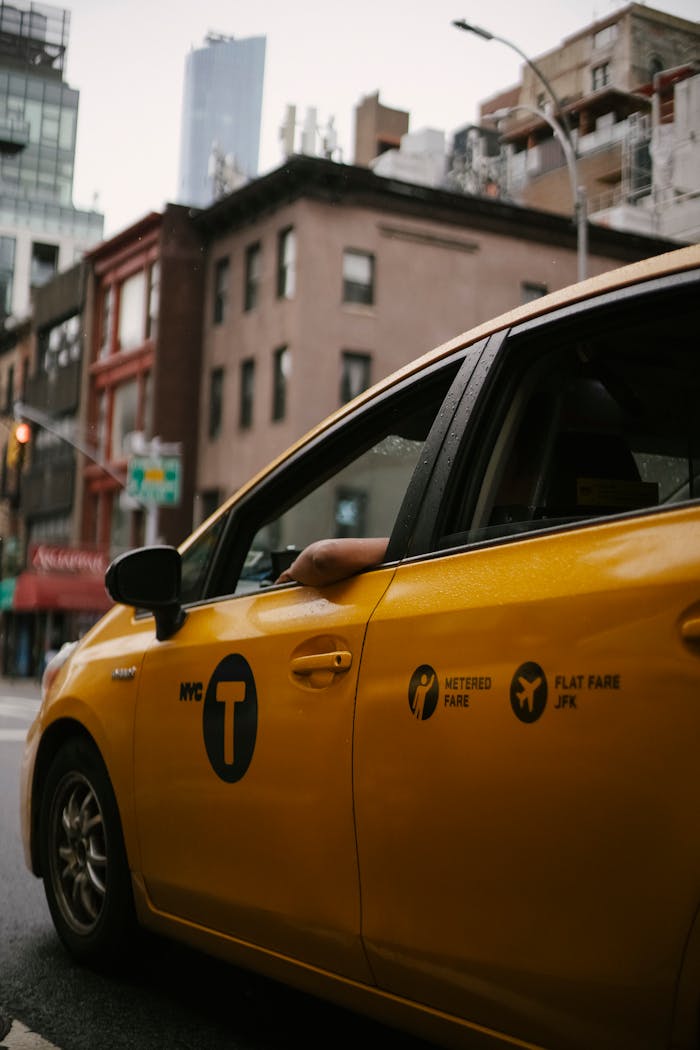 A classic NYC yellow taxi on a bustling urban street, capturing city life and transport.